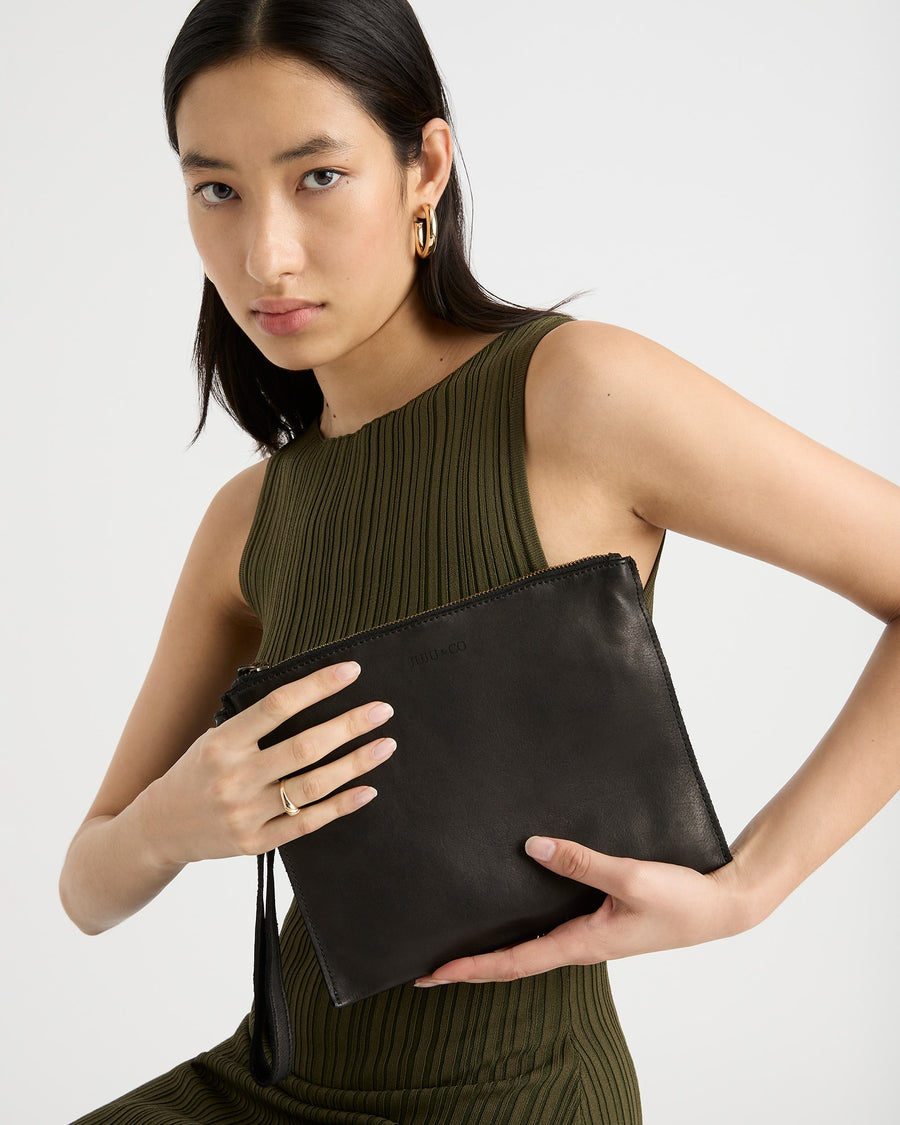 woman holding black bag